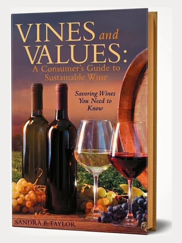 Cover of Vines and Values: A Consumer's Guide to Sustainable Wine by Sandra E. Taylor — wine bottles and glasses beside a barrel at dusk